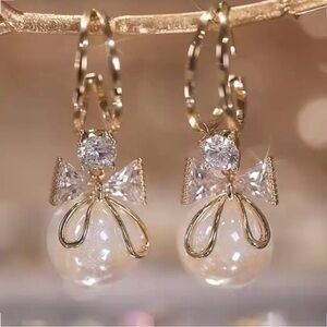 Gold and Pearl Bow Earrings.